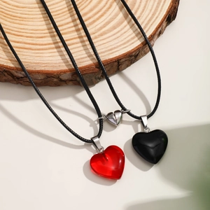 Vintage magnetic heart necklaces for couples with red and black charms on wax ropes