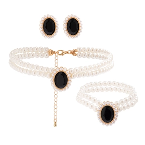 Détail de parure bijoux en perles double rang avec gemmes noires et finitions dorées
