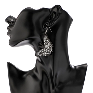 Close-up of gothic acrylic butterfly earrings with skull and skeleton bone patterns