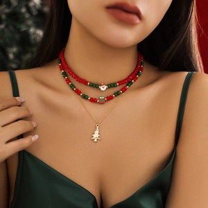 Close-up of triple-layered Christmas necklace with beaded Santa, gift box, and tree charms