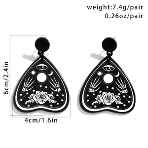 Detail view of heart-shaped acrylic earrings with dimensions 6cm by 4cm and 7.4g weight