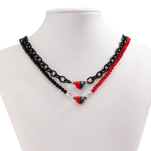Detail of red and black heart pendant necklace with double-layer beaded chain on a bust