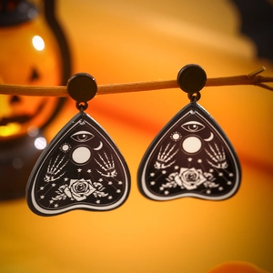 Gothic planchette acrylic drop earrings with skeletal hands and mystic rose on wood branch