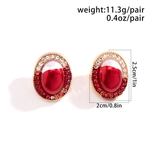 Macro detail of gothic oval earrings with red stones and dimensions 2.5cm by 2cm