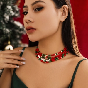 Close-up of layered Christmas beaded necklace with Santa and HO HO HO charms