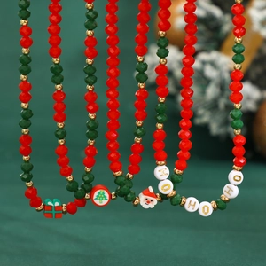 Macro detail of Christmas snowman choker with red and green beads and festive charms