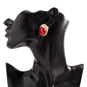 Detail of vintage gothic oval stud earring with red gemstone and crystals on model