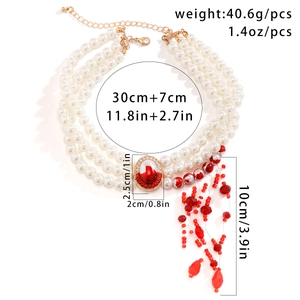 Detailed specs of gothic pearl choker with red gem pendant and blood-drop tassels