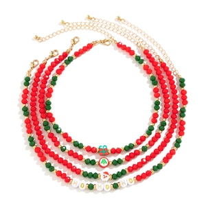 Detail of 4-piece Christmas beaded choker set with festive pendants and HO HO HO charms