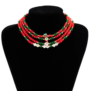 Detail of multi-layer Christmas choker featuring red and green crystal beads and charms