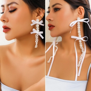Exaggerated long pearl drop earrings with elegant white satin bows for women