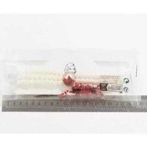 Detailed view of gothic pearl choker length measurement with red gemstone pendant