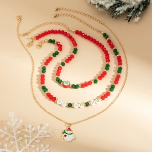Close-up of Christmas necklace set with red green beads and snowman pendant