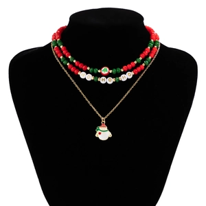 Close-up of triple-layer Christmas necklace with snowman pendant and green-red beads