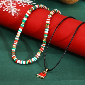 Detail of Christmas beaded necklace set with clay discs and festive bell pendant