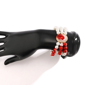 Close-up of triple-layer pearl bracelet with red blood drip effects for Halloween style