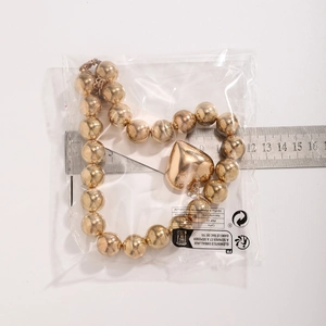 Detailed size measurement of a chunky gold bead necklace with large heart pendant