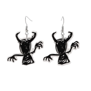 Detail of Halloween acrylic drop earrings with black hand-drawn monster doodle designs