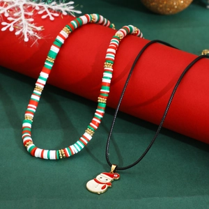 Detailed close-up of Christmas snowman pendant necklace with festive clay heishi beads