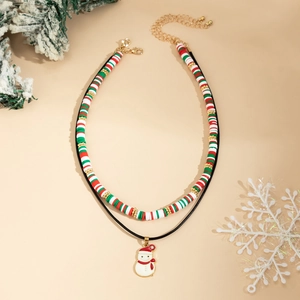 Detail of Christmas snowman pendant and red white green clay beads layered necklace