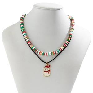 Detail of Christmas snowman pendant and red, white, green polymer clay bead necklace