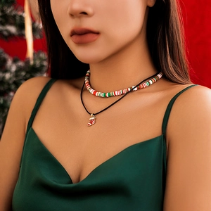 Close-up of a dual-layer Christmas necklace set with colorful clay beads and a red sock charm