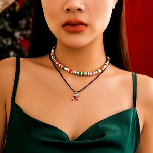Detailed view of layered Christmas choker with festive clay beads and stocking charm