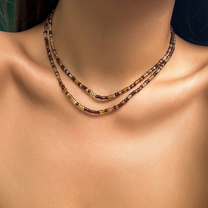 Close-up of double-layer beaded necklace with starfish and shell accents on neck