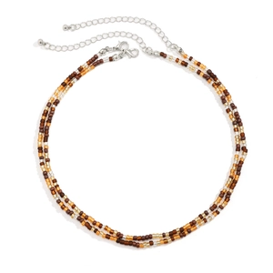 Detail of beaded shell necklace with lobster clasp and adjustable silver extension chain