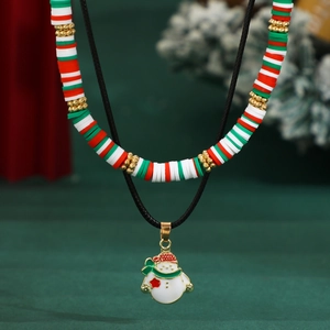 Close-up of Christmas layered necklace with red, green heishi beads and snowman pendant