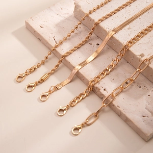 Detailed set of five gold plated punk style chains including snake and beaded link anklets