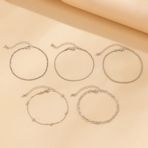 Detail view of 5-piece silver heart charm beaded punk chain anklet set with lobster clasps