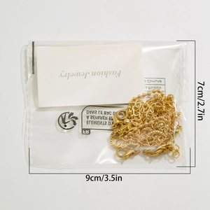 Detailed packaging view showing gold anklet set in a 9x7cm pouch with lobster clasp