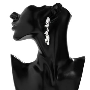 Detailed view of silver liquid metal irregular earrings on a black display mannequin