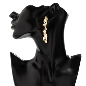 Close-up of irregular liquid gold long earrings with lava texture on a black model