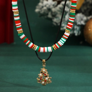 Macro detail of Christmas tree pendant with colorful rhinestones on beaded choker necklace