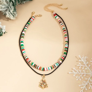 Detail of Christmas double-layer necklace with snowman heishi beads and gold tree pendant