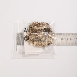 Close-up measurement of a golden hammered metal disc pendant necklace with 6cm diameter