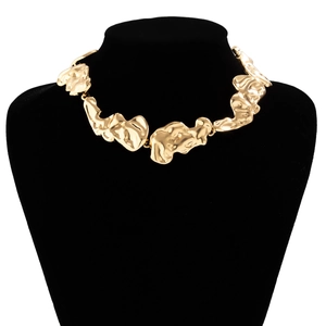 Close-up of golden irregular liquid-style metal lava link necklace on a neck model