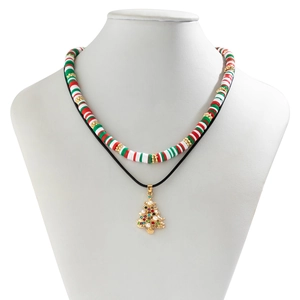 Detail of double-layer Christmas necklace with red green clay beads and golden tree pendant