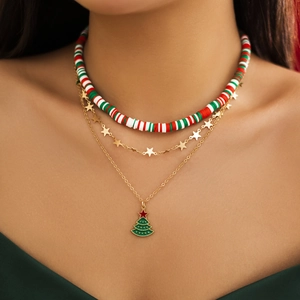 Close-up of three-layered Christmas choker with beaded strand and festive tree pendant