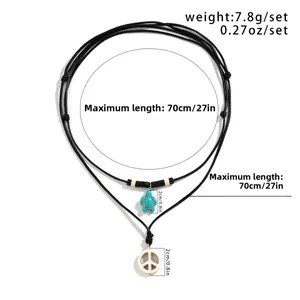Detail of adjustable double-layer beaded necklace with sea turtle and peace sign charms