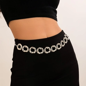 Detailed view of silver irregular hammered metal rings on a stylish waist chain accessory