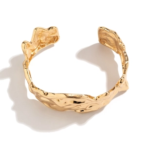 Golden irregular liquid lava style open cuff bracelet with artistic metallic texture