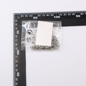 Detailed view of silver heart beaded punk anklet set inside packaging with ruler measurement