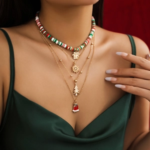 Close-up of layered Christmas necklace with beaded choker and festive enamel charms