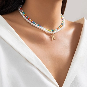 Close-up of double-layer beaded necklace with colorful seed beads and a gold starfish charm