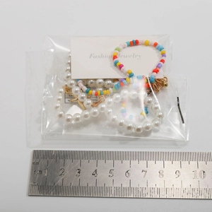 Detailed view of colorful beaded necklace with starfish charms and white faux pearls