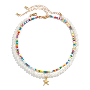 Detail of double-layer necklace with colorful seed beads and gold starfish pendant