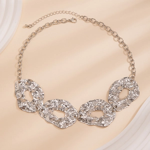Irregular silver geometric statement necklace with textured metal plates and toggle chain